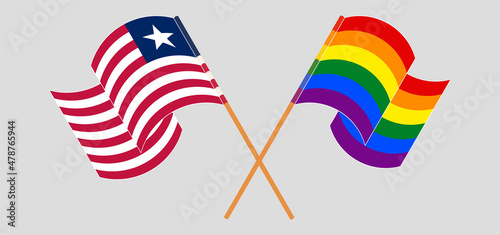 Crossed and waving flags of LGBTQ and Liberia