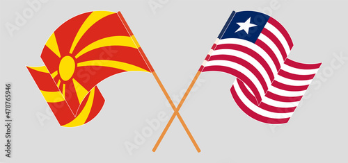 Crossed and waving flags of North Macedonia and Liberia
