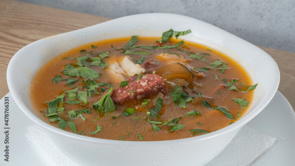 Traditional Russian soup Solyanka with beef, chicken, sausage, lemon, olives and pickled cucumber. Delicious hot lunch. Traditional Russian soup Solyanka with beef, chicken, sausage, lemon, olives and pickled cucumber. Delicious hot lunch.