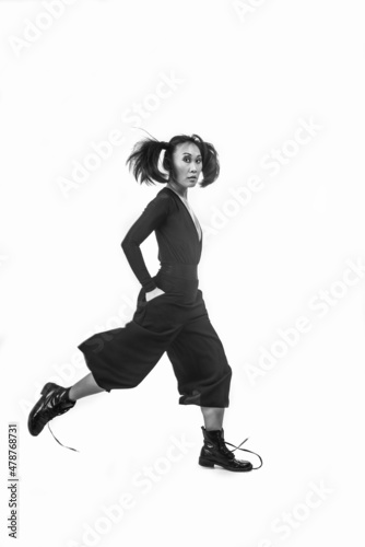 Korean woman with pigtails jumping on a white background