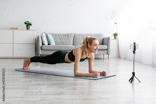 Fitness blog. Lady shooting tutorial sports exercises for internet channel at social media at home