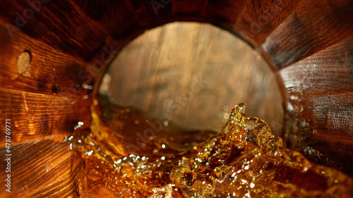 Freeze motion of splashing whisky in barrel photo