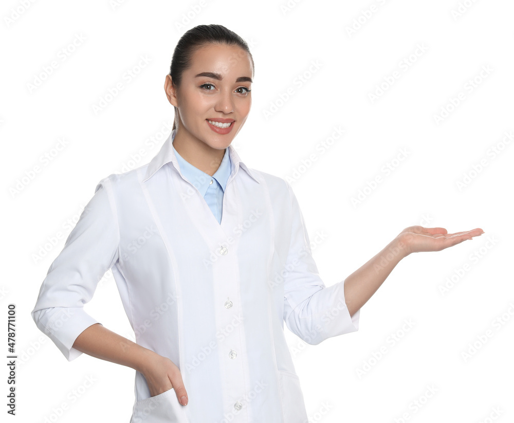 Beautiful young doctor showing something on white background Beautiful young doctor showing something on white background