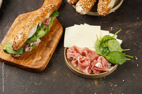 Εκτύπωση καμβά Long sandwich in brown lye bread sticks garnished with oats , pork slices prosci