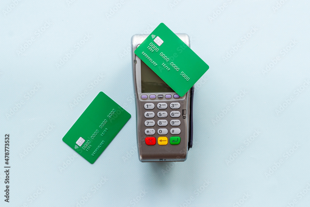 E-commerce and payment concept. Pos terminal with credit cards top view E-commerce and payment concept. Pos terminal with credit cards top view