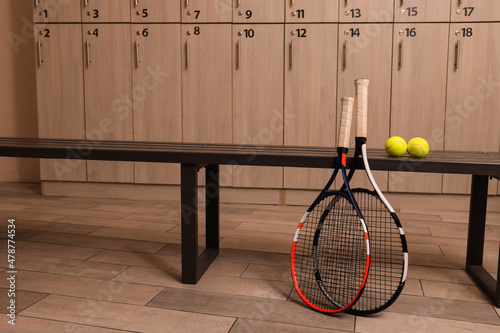 фотографія Tennis racket and balls in locker room