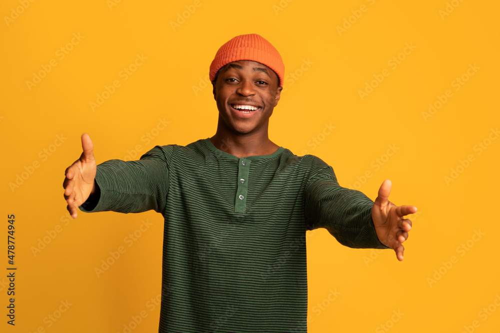Give Me Hug. Portrait Of Cheerful Black Guy Stretching Hands At Camera