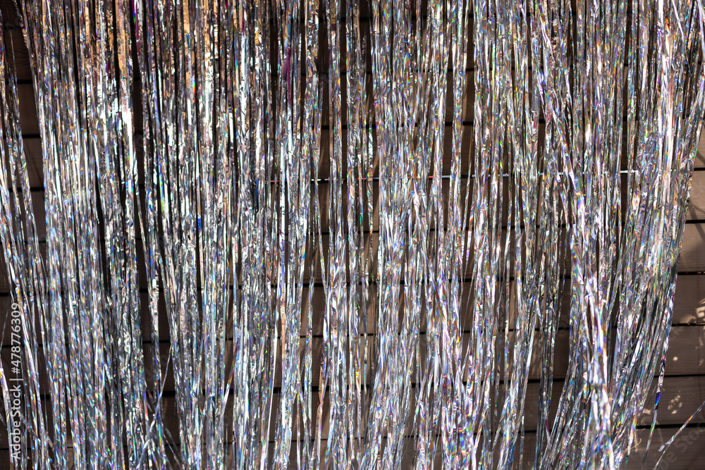 Obraz premium Festive background. Shiny tinsel in silver shines.