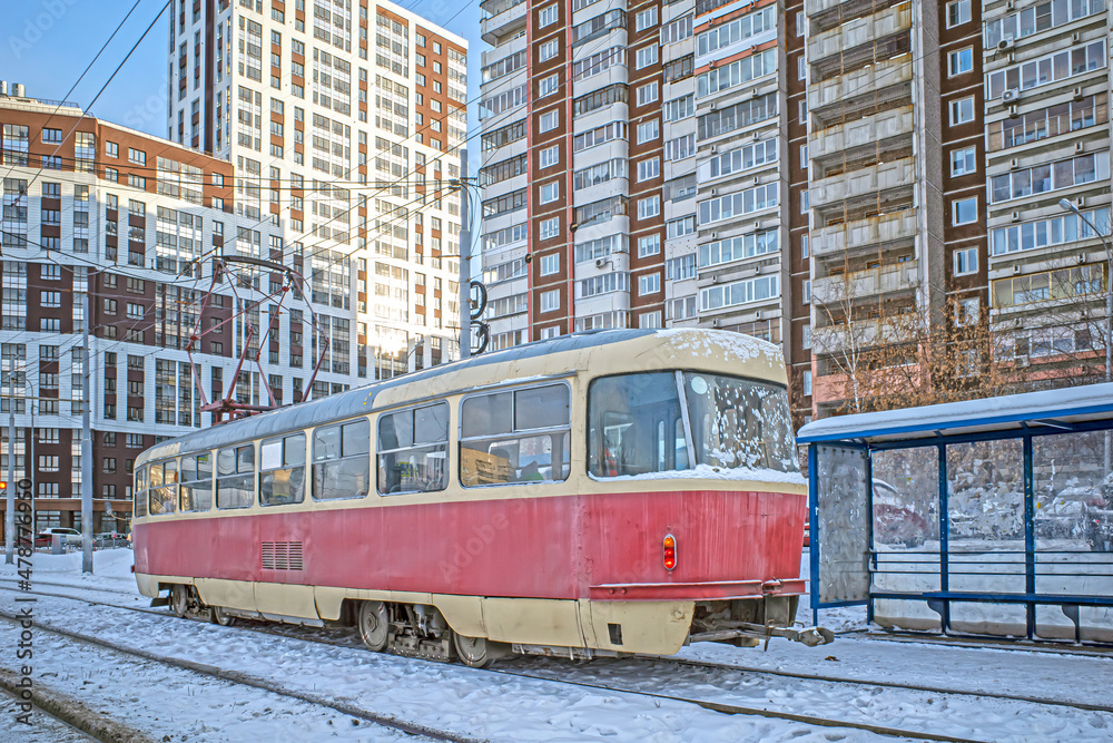 City tram at a stop on a winter day