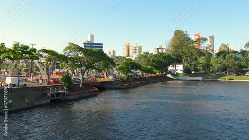 Higienopolis avenue on the banks of Igapo Lake of Londrina city at Parana state. Zoom out video. photo