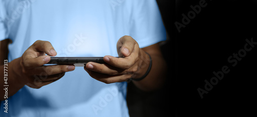 Close up of a man using mobile smart phone and copy space