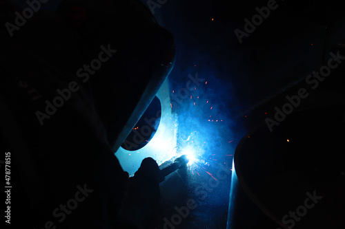 Blue Collar Workers - metal welder, Welding argon, Results welding on the metal of the foreground stock photo