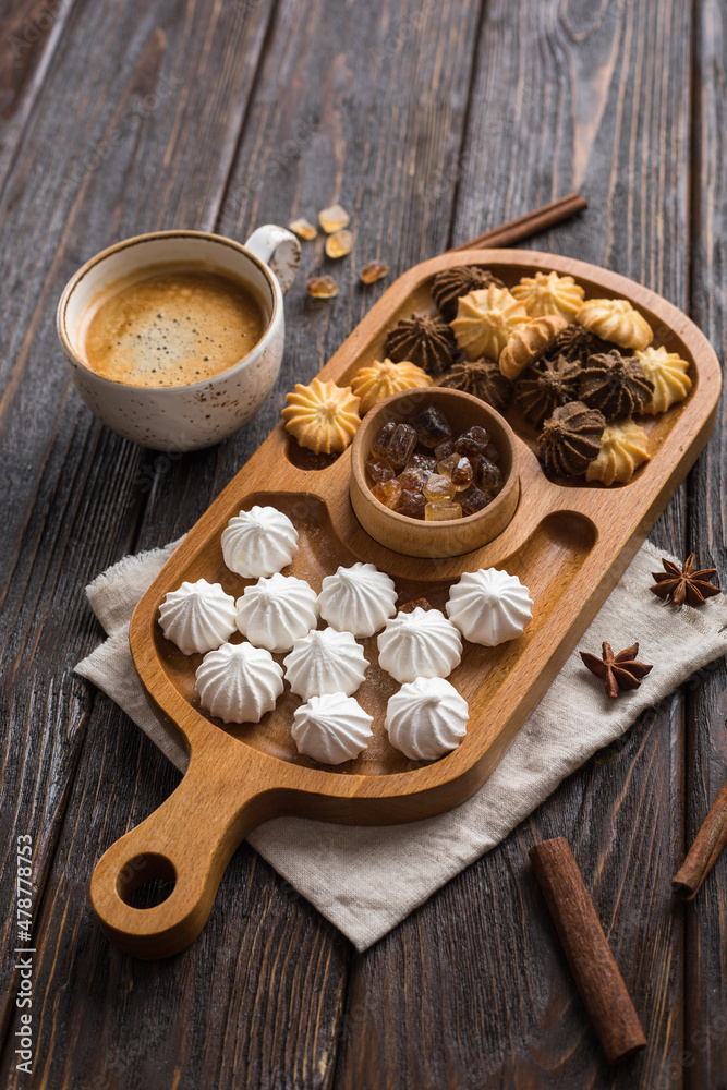 Fototapeta premium Mini meringue, cookies and coffee on a wooden table