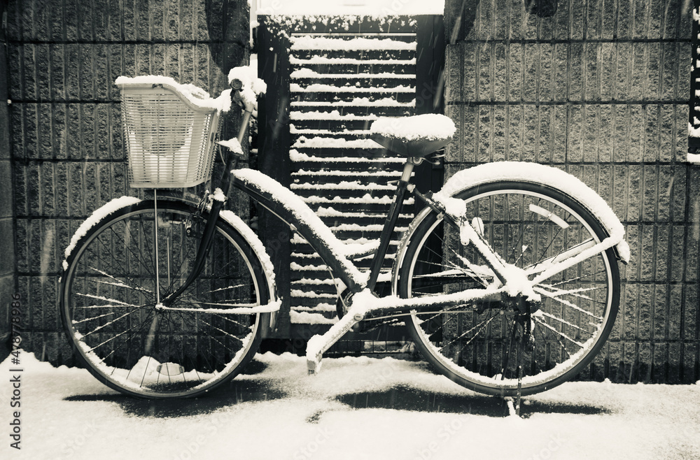 black and white old snow covered bicycle on the street black and white old snow covered bicycle on the street