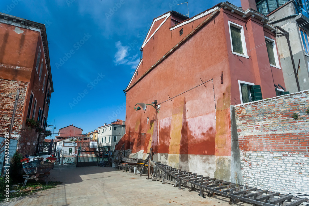 Courtyard and old houses, abandoned vintage gondola boats around island of Giudecca. Venice city area.