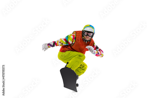 One young woman in bright sportswear, goggles and helmet snowboarding isolated on white studio background. Concept of winter sports