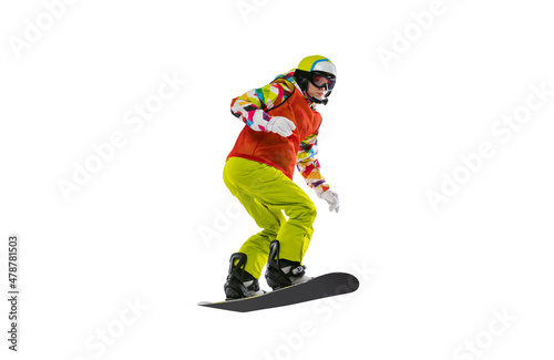 Portrait of young woman in bright sportswear, goggles and helmet snowboarding isolated on white studio background. Concept of winter sports