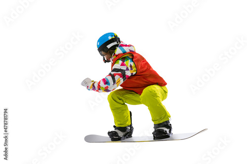 Portrait of young woman in bright sportswear, goggles and helmet snowboarding isolated on white studio background. Concept of winter sports