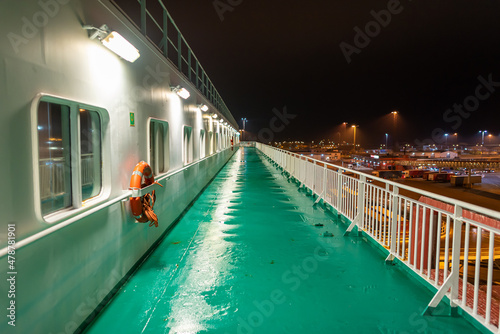 Promenade deck of a ro-ro ship and cruiseferry in the harbor of Ystad at night. The ferry connects the city of Świnoujście in Poland and Ystad in Sweden photo