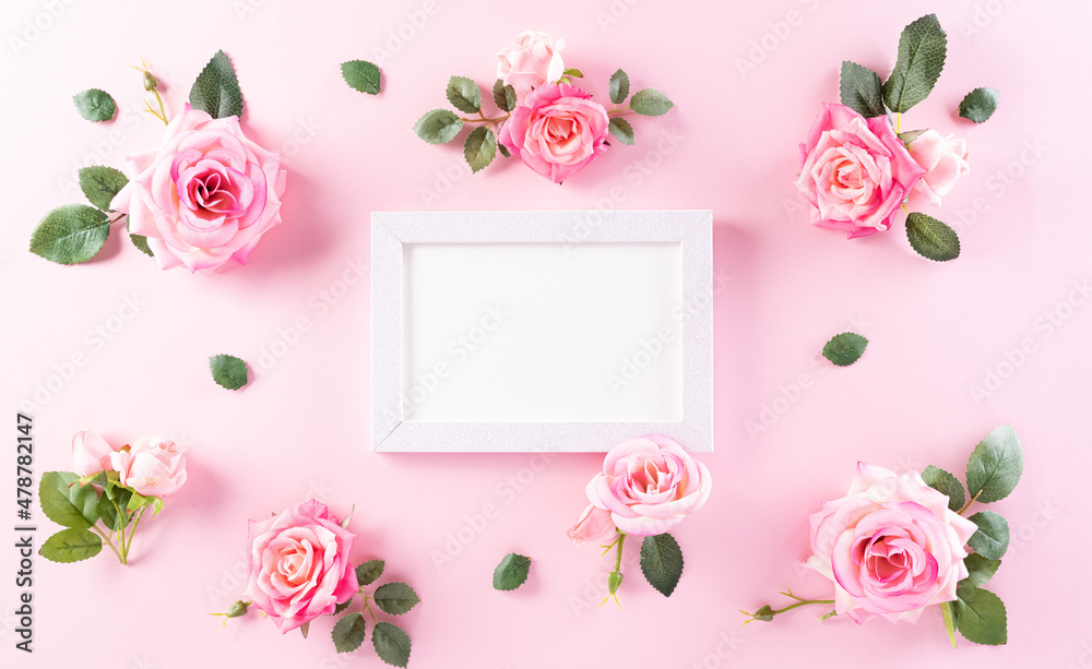 Happy Women's Day decoration concept. Top view of roses flower with picture frame on pink pastel background. Happy Women's Day decoration concept. Top view of roses flower with picture frame on pink pastel background.