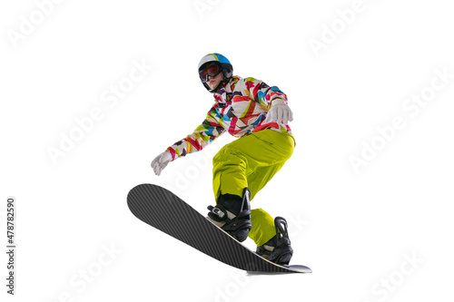 Young sportive woman in bright sportswear, goggles and helmet snowboarding isolated on white studio background. Concept of winter sports