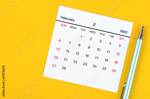 February 2022 calendar on yellow background.