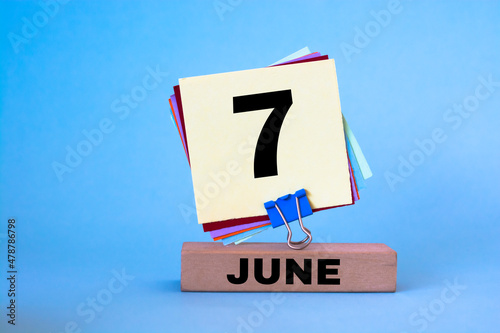 June 7th. Image of June 7 wooden color calendar on blue background. Summer day, empty space for text