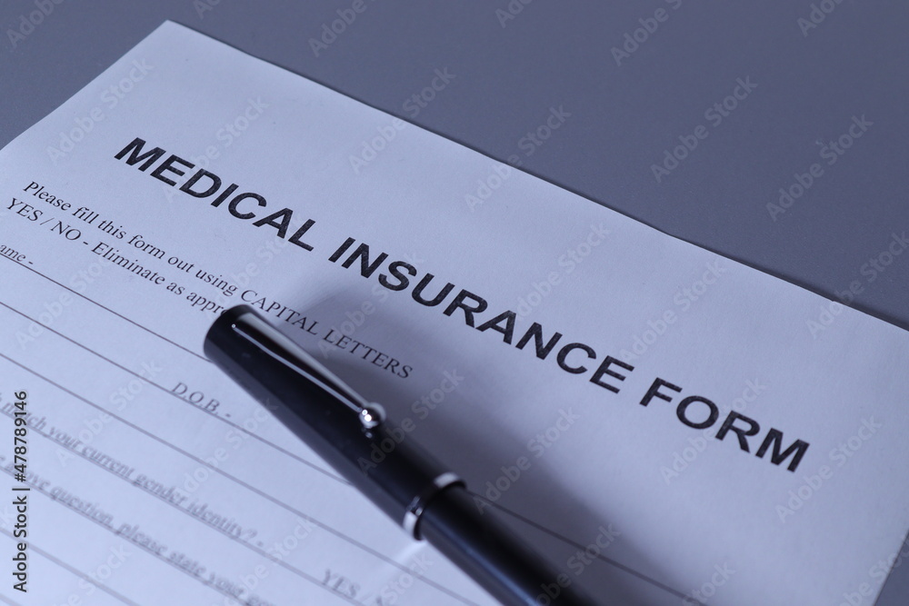 Medical Insurance Form with pen lain across the page