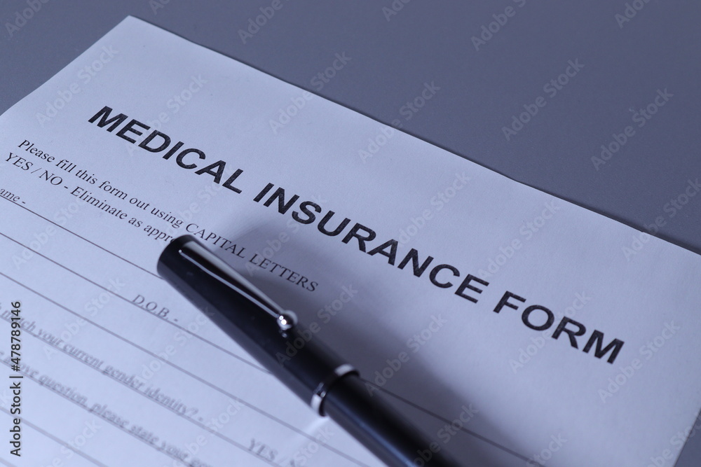 Medical Insurance Form with pen lain across the page Medical Insurance Form with pen lain across the page