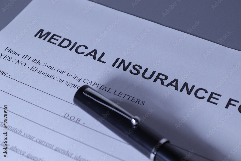 Medical Insurance Form with pen lain across the page