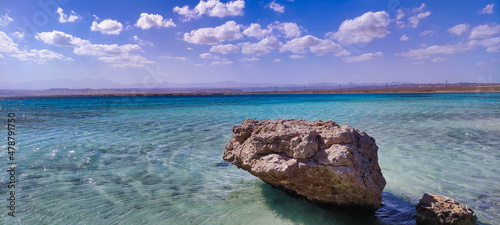 View of Sharm el Luli beach in Egypt. Red Sea and white sand. Blue water and sky. Big white stone in the sea