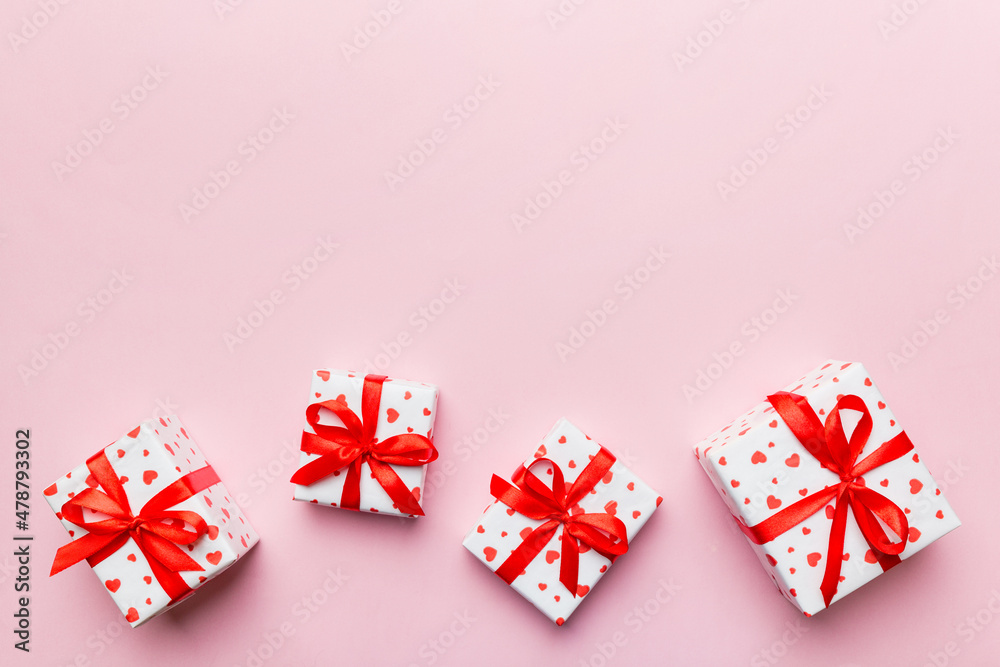 Valentine day composition: red gift box with bow and heart. Christmas present. View from above. Space for text. Holday greeting card Valentine day composition: red gift box with bow and heart. Christmas present. View from above. Space for text. Holday greeting card