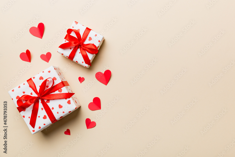 Valentine day composition: red gift box with bow and heart. Christmas present. View from above. Space for text. Holday greeting card Valentine day composition: red gift box with bow and heart. Christmas present. View from above. Space for text. Holday greeting card