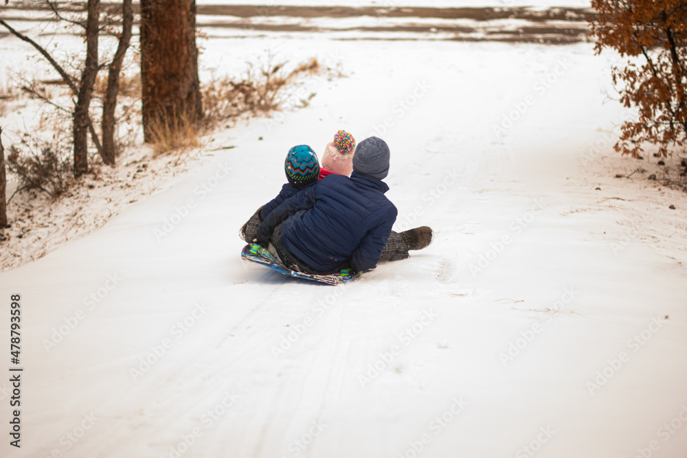 kids sledding down snow kids sledding down snow