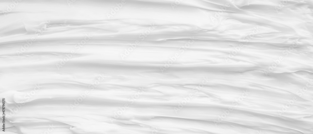 Fototapeta premium White surface of the cream lotion softens the background.