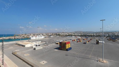 Crete, Greece - 23 August 2021: docked cruise ship port zone with tent terminal and cargo freight containers photo