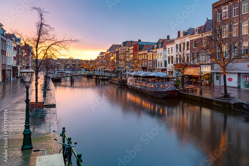 Leiden canal Oude Rijn with trees in Christmas illumination at sunrise  South Holland  Netherlands.