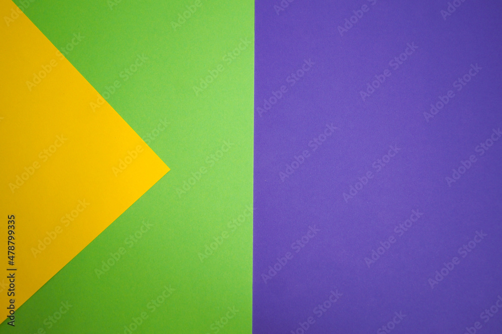 Graphic background of different geometric shapes in 3 colors: green, yellow, purple. Space copy. Trend colors.
