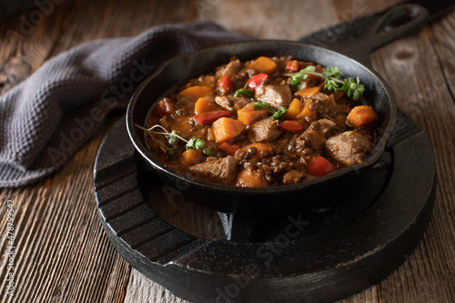 High protein fitness meal with a spicy chicken stew with vegetables and lentils on wooden table