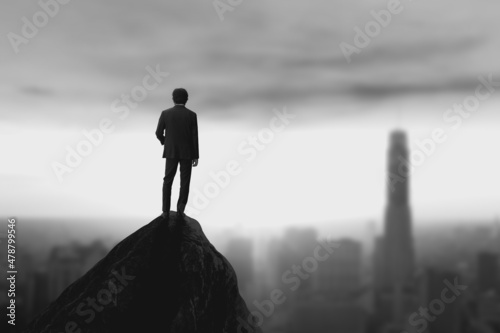 Young businessman wearing casual suit standing on top of the mountain with cityscape view and looking forwards, success, competition and leader concept.
