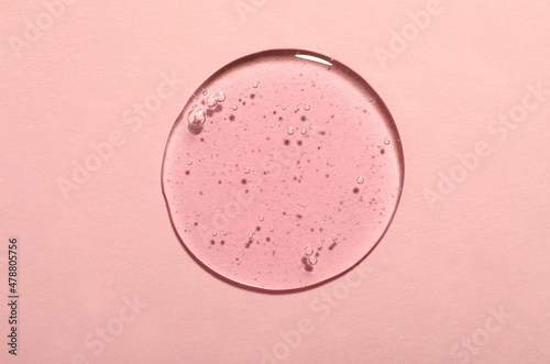 Sample of cosmetic gel on pink background, top view photo