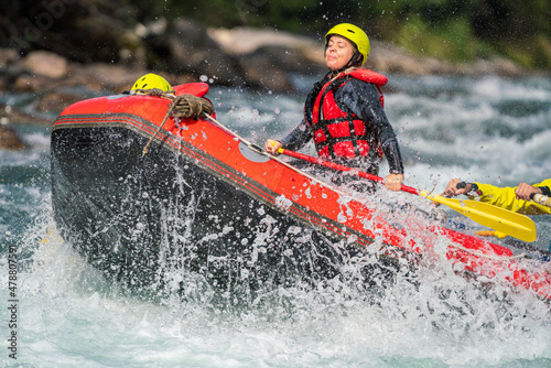 Girl are rafting in river, big watersplash over boat. Extreme sports, water activity and adrenaline concept. © Jon Anders Wiken
