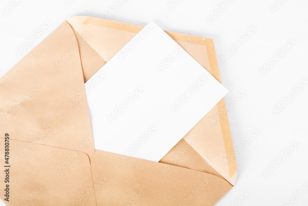 Opened craft paper envelope with empty piece of paper isolated on white background Opened craft paper envelope with empty piece of paper isolated on white background