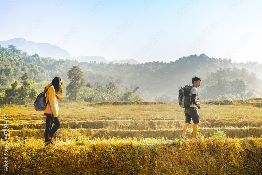 adventure travel from asian couple hiking and walk to the mountain in summer season