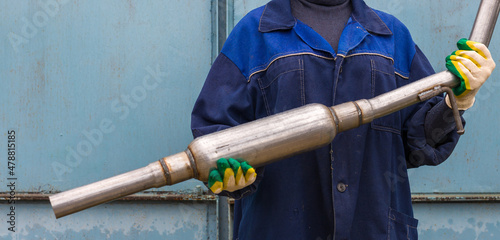 new muffler for the car in hand