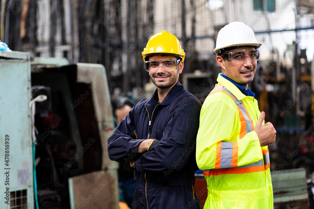 Two electrician Man Worker at industrial factory wearing uniform and hard hats and Mechanical repair. Engineer Operating lathe Machinery Two electrician Man Worker at industrial factory wearing uniform and hard hats and Mechanical repair. Engineer Operating lathe Machinery