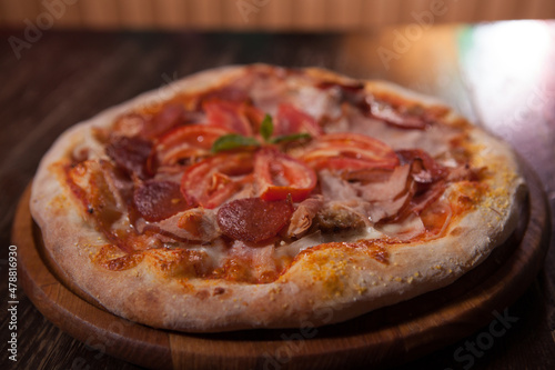 Close up of delicious fresh meat pizza with ham and salami