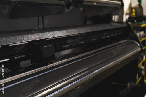 Modern plotter laser cutter machine in print house industry, close-up view photo