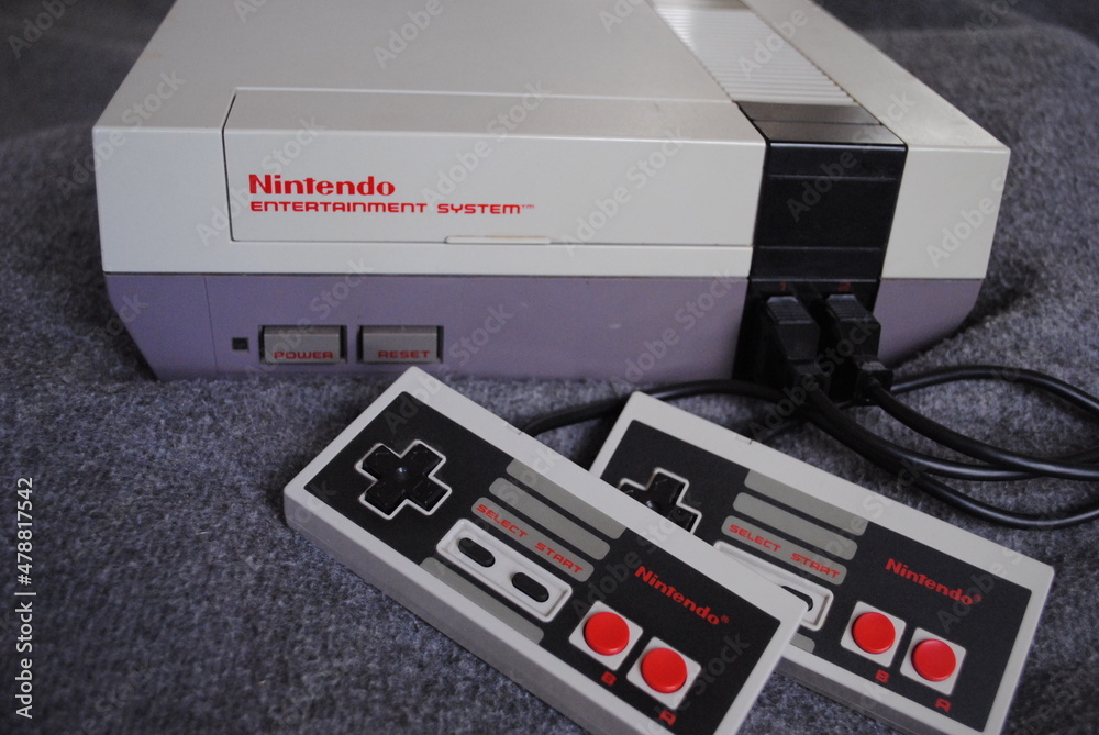 The Nintendo Entertainment System (NES), an 8-bit third-generation home  video game console produced by Nintendo. NES Control Deck home video game  console with controllers. Stock Photo | Adobe Stock