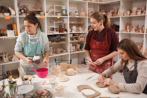 Canvas Print Three women working at ceramics studio